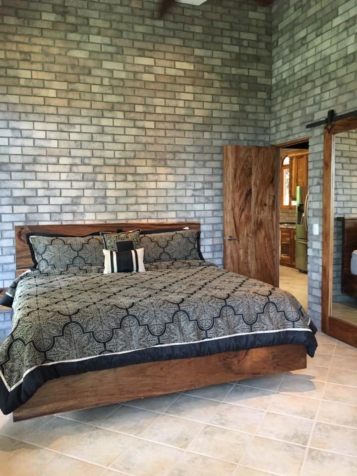 Bedroom with a Wire Cut Gray brick veneer wall